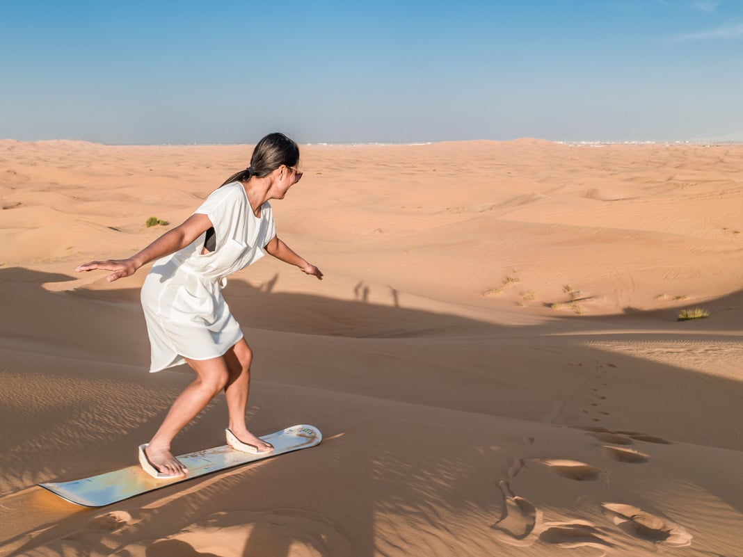 Dubai dessert sand dunes, couple on Dubai desert safari,United Arab Emirates, woman vacation in Dubai